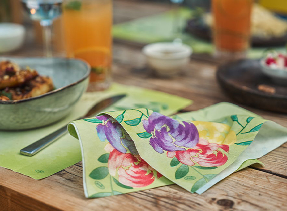 Sustainable floral napkin folded casually on a table with food